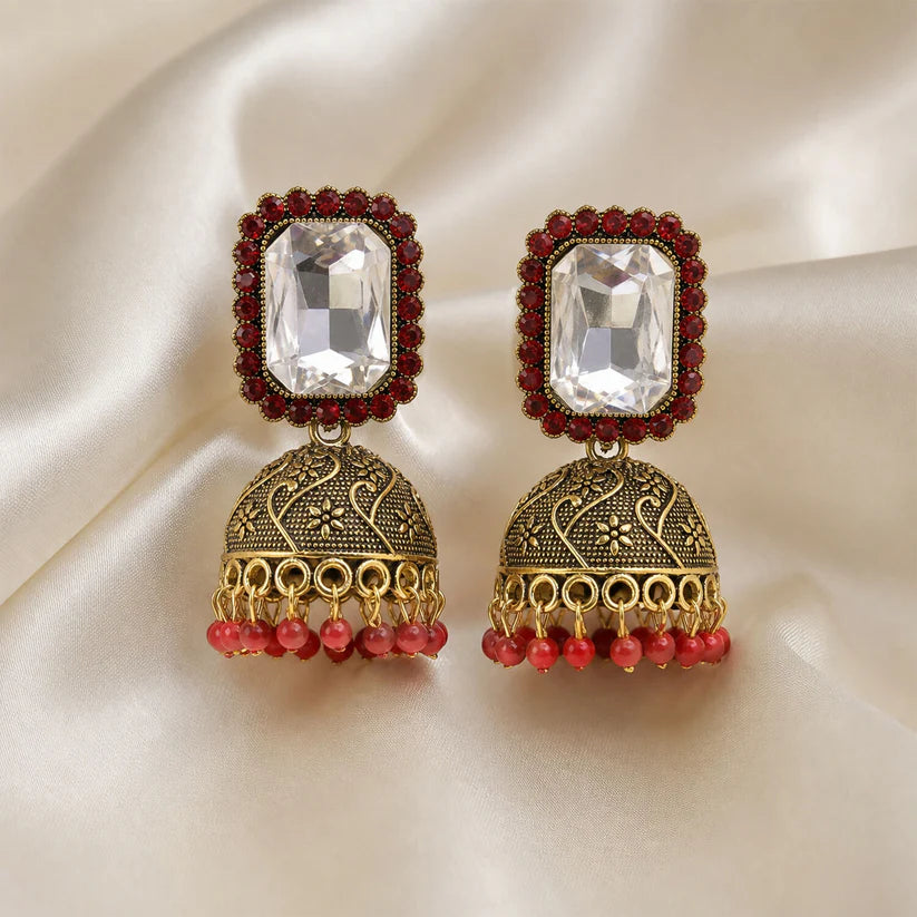 Red stone antique gold jhumka earrings with clear center stud design